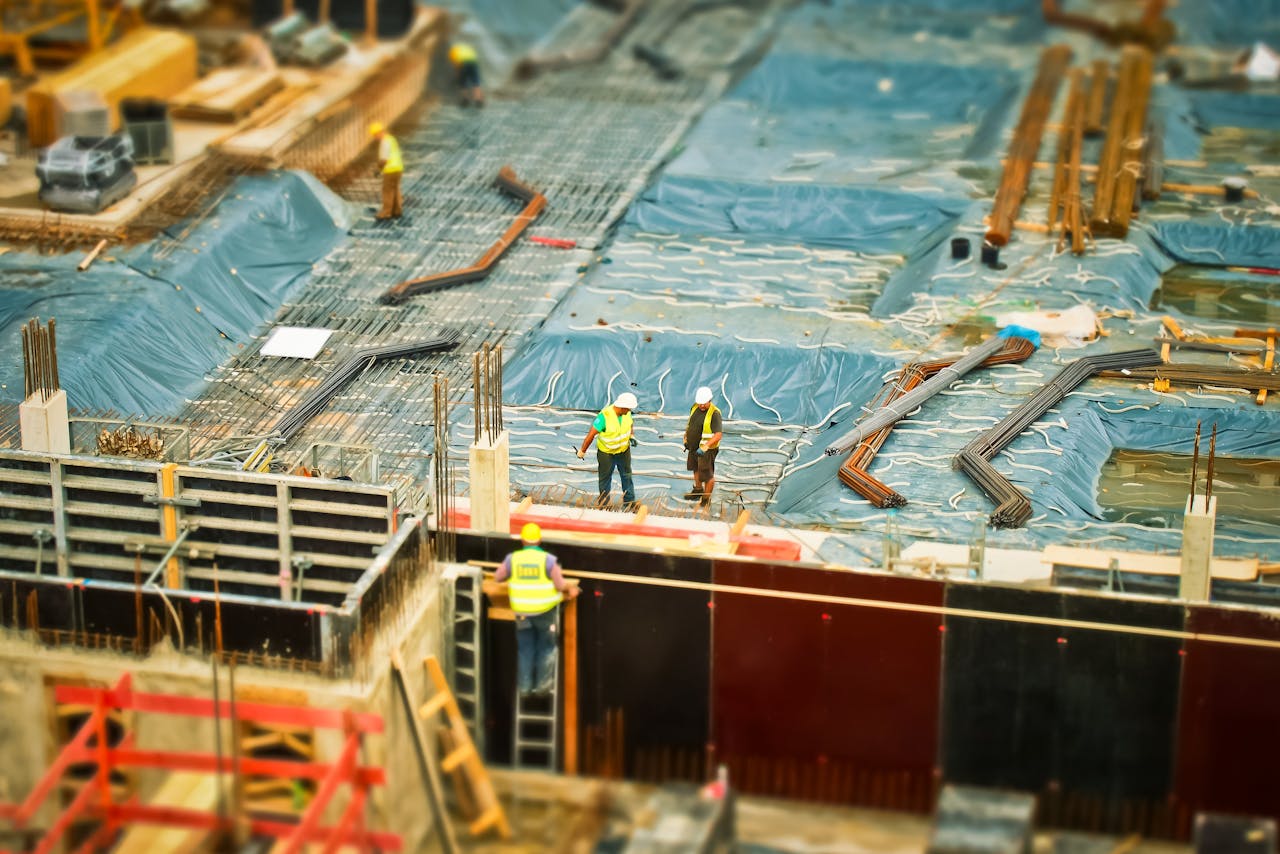 Home High-angle view of construction workers on a building site, engaging in construction work.